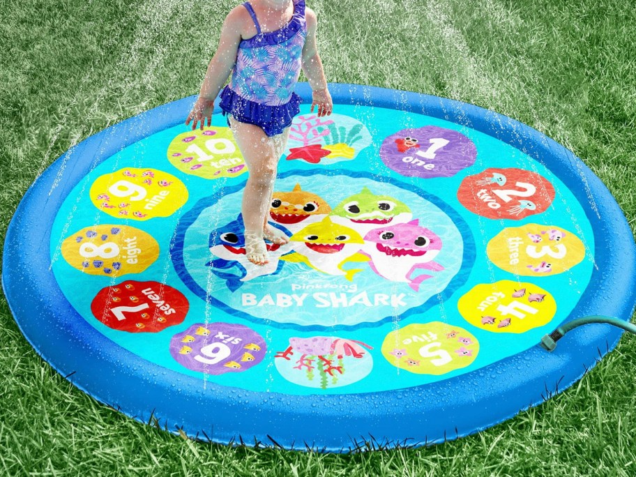 child playing on baby shark splash pad 