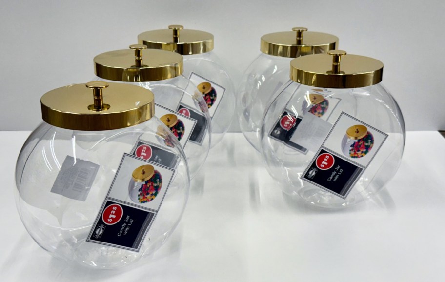 plastic candy jars with lids arranged on a table