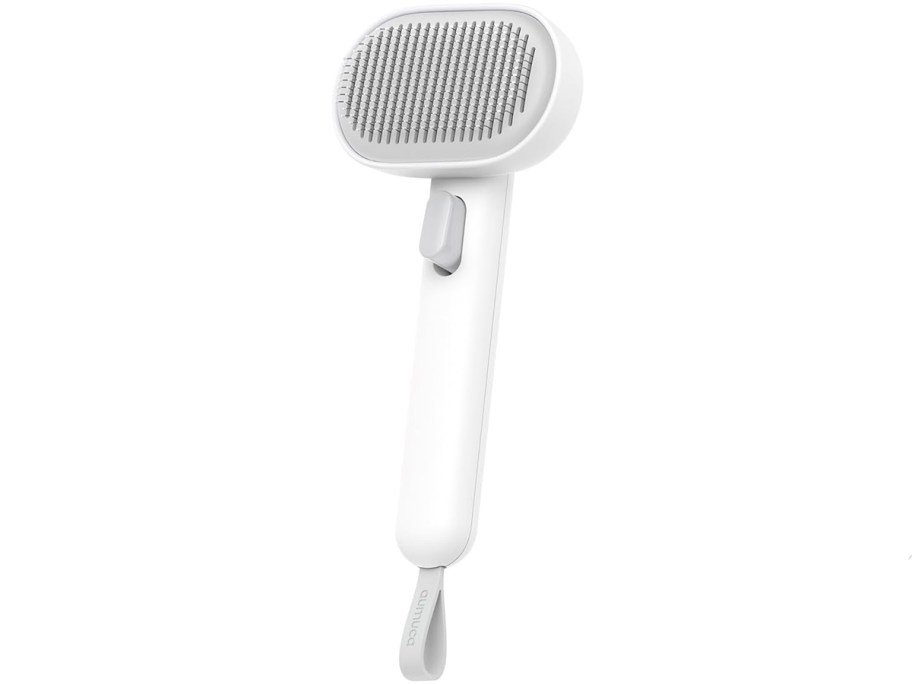 white and gray cat deshedding brush