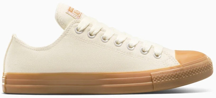 white and tan low top converse shoe