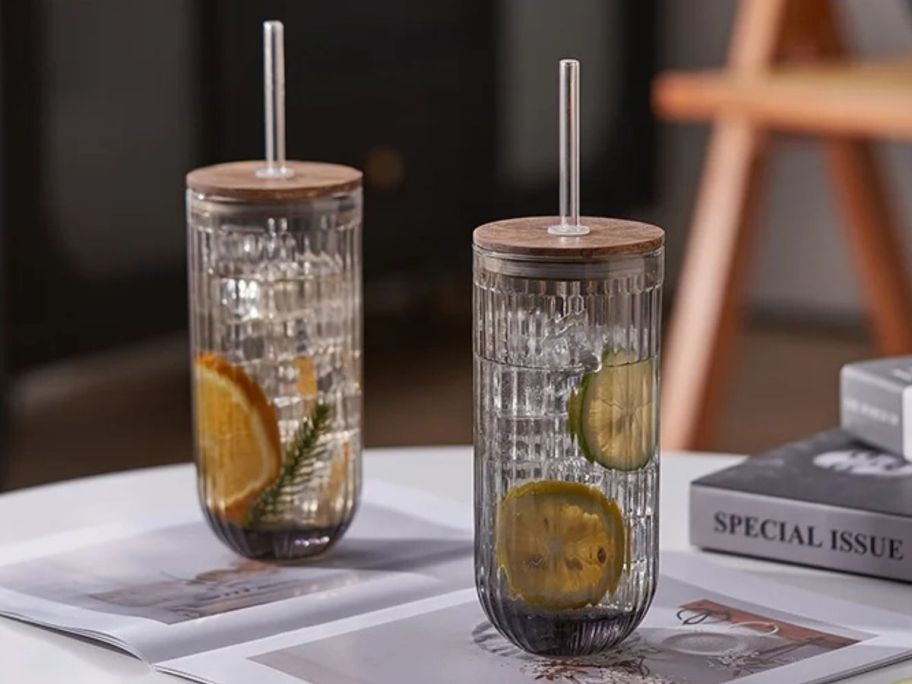 two clear Better Homes & Gardens Rib Smoke Glass Tumblers on table with clear liquid and fruit slices in them