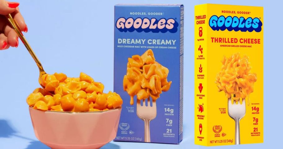 two boxes of goodles mac and cheese next to a bowl filled with mac and cheese