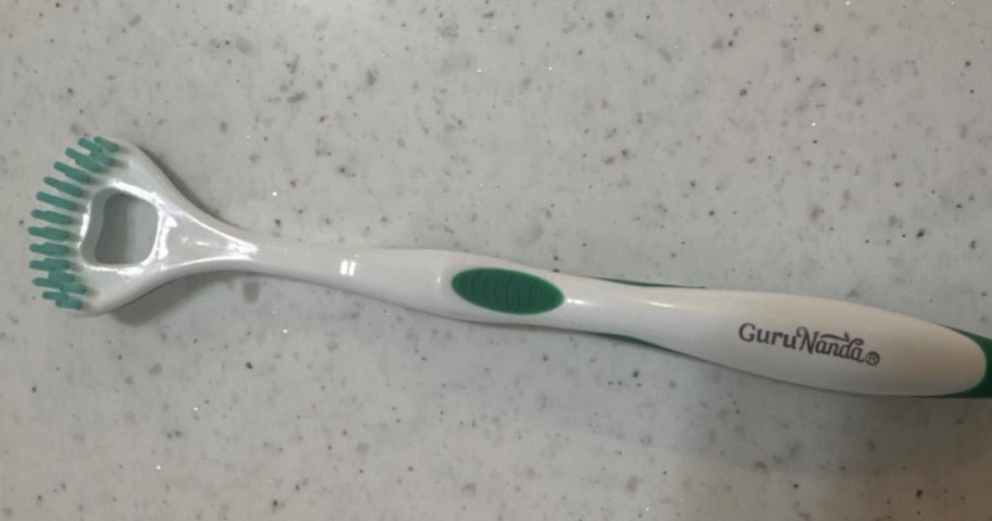tongue scraper on bathroom counter