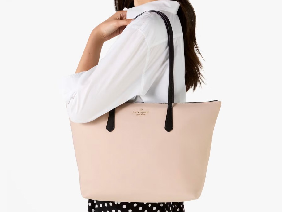 woman wearing tan tote 