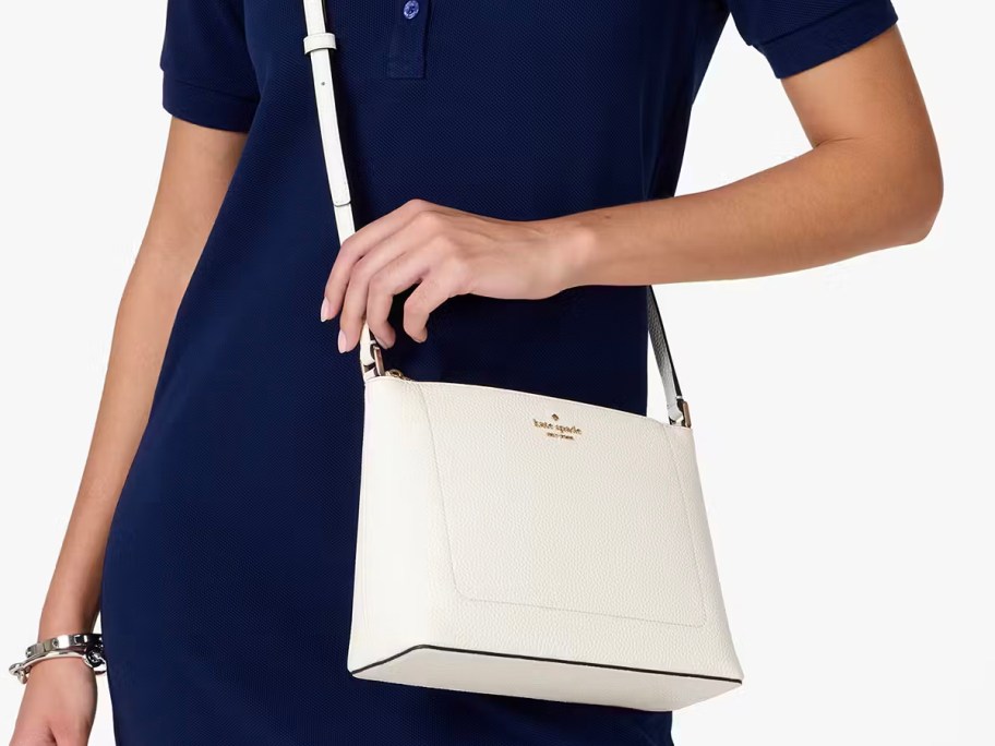 woman in blue dress wearing white crossbody bag