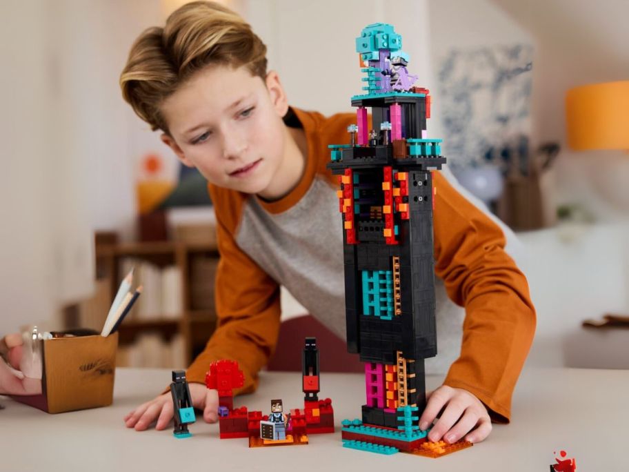 kid playing with LEGO Minecraft The Enderman Tower