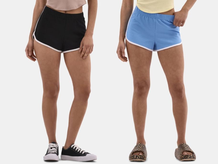 two women wearing No Boundaries Women's Jersey Knit Dolphin Shorts in black and blue