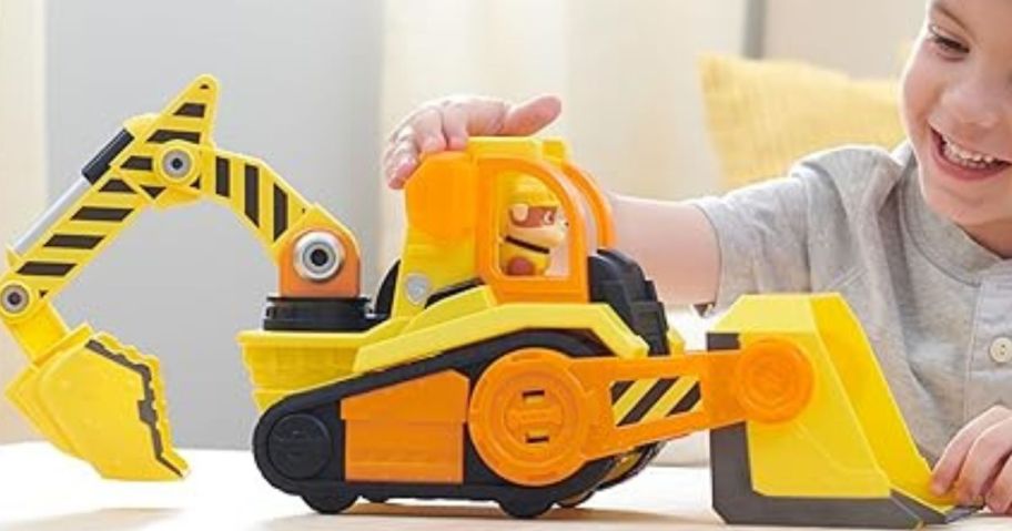 kid playing with Rubble & Crew Bark Yard Deluxe Bulldozer Construction Truck
