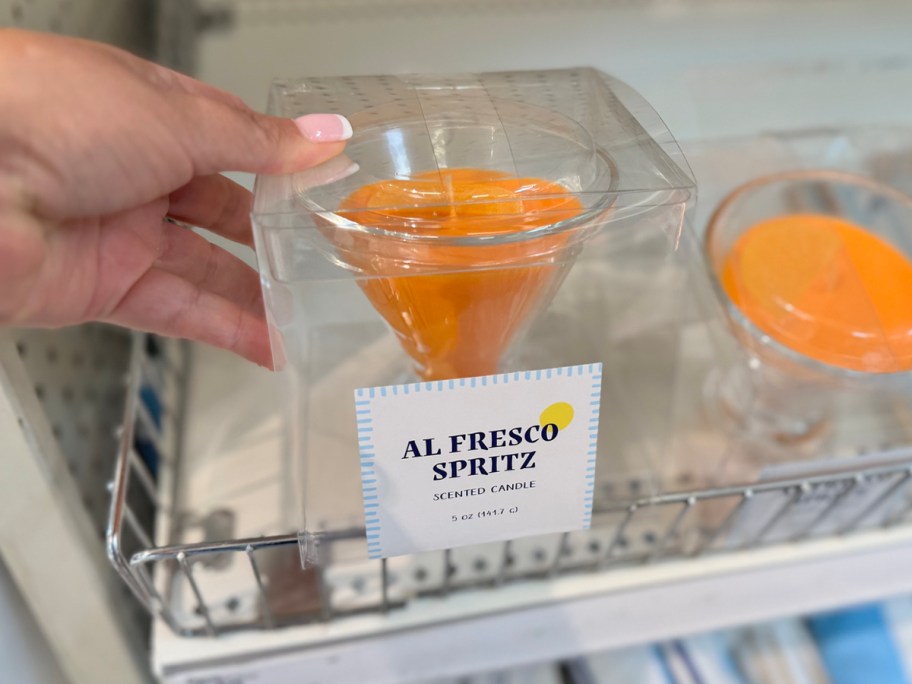 orange Al Fresco Spritz Scented Candle package in hand in store