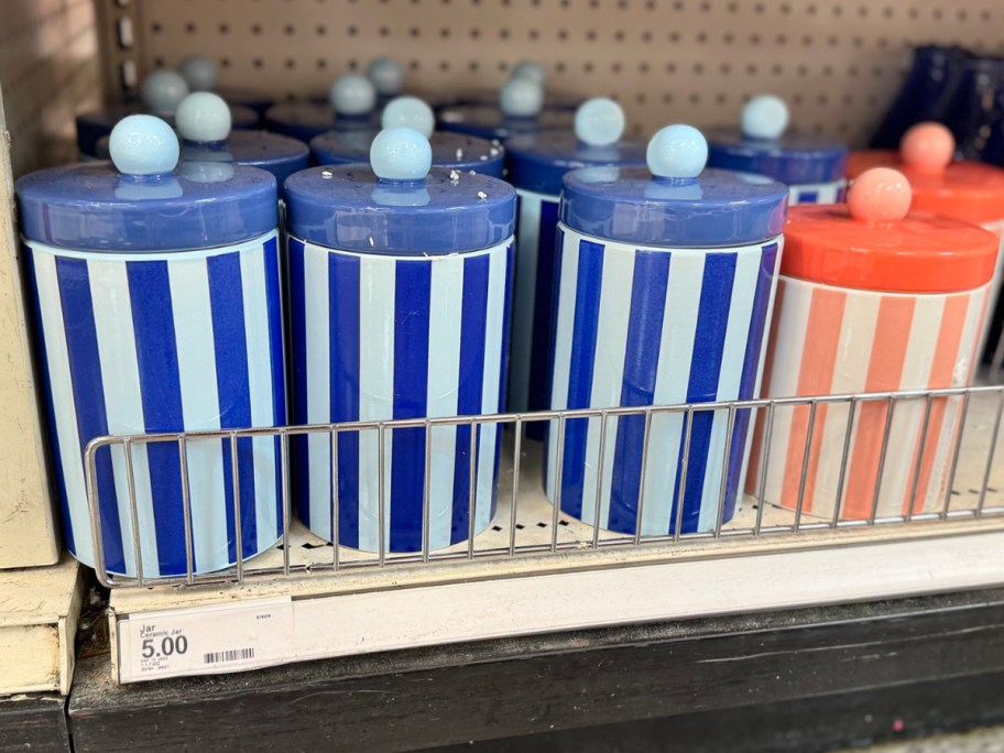 blue and white striped ceramic jars on shelf in store