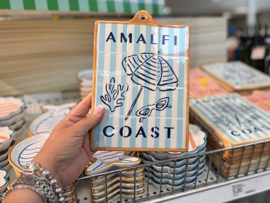 Amalfi Coast blue and white striped ceramic wall decor board in hand in store
