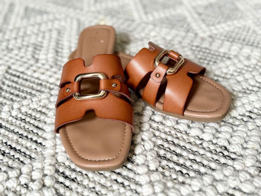 brown Time and Tru Women's Hardware Slide Sandals on black and white rug