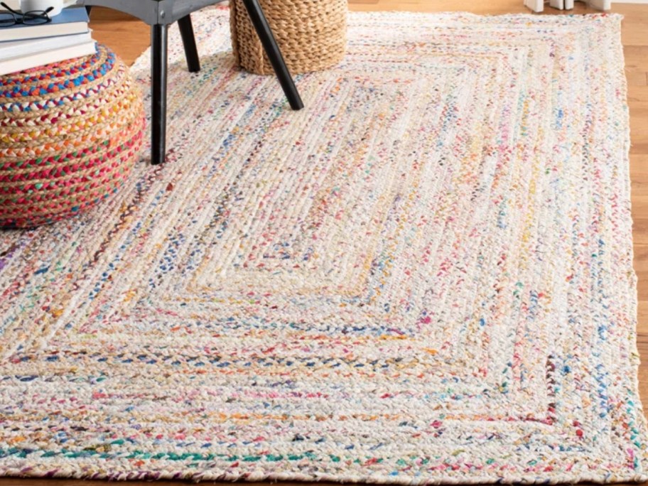 a cream and multi color area rug in a living room