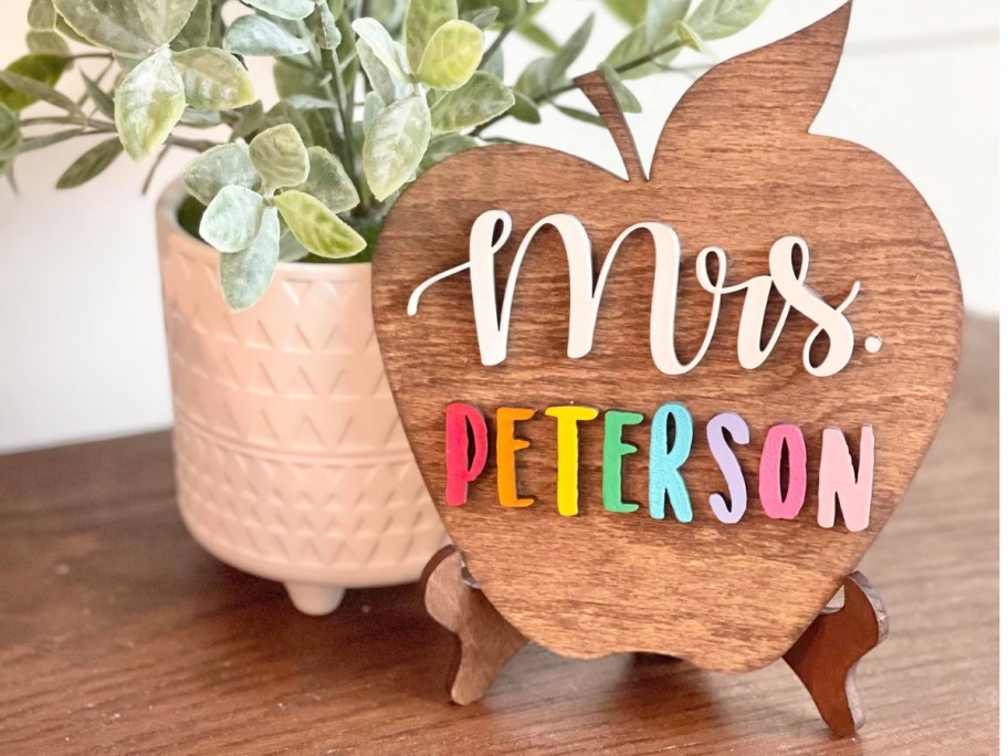 a Personalized Desktop Teacher Apple Sign with the teacher's name next to a plant