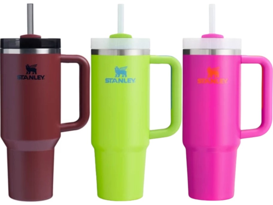 a dark red, lime green, and hot pink Stanley tumbler