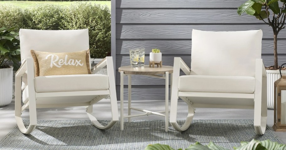 a white and off white 2 piece rocker set on a patio