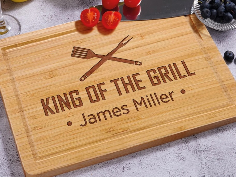 a personalize wood cutting board that says "king of the grill"