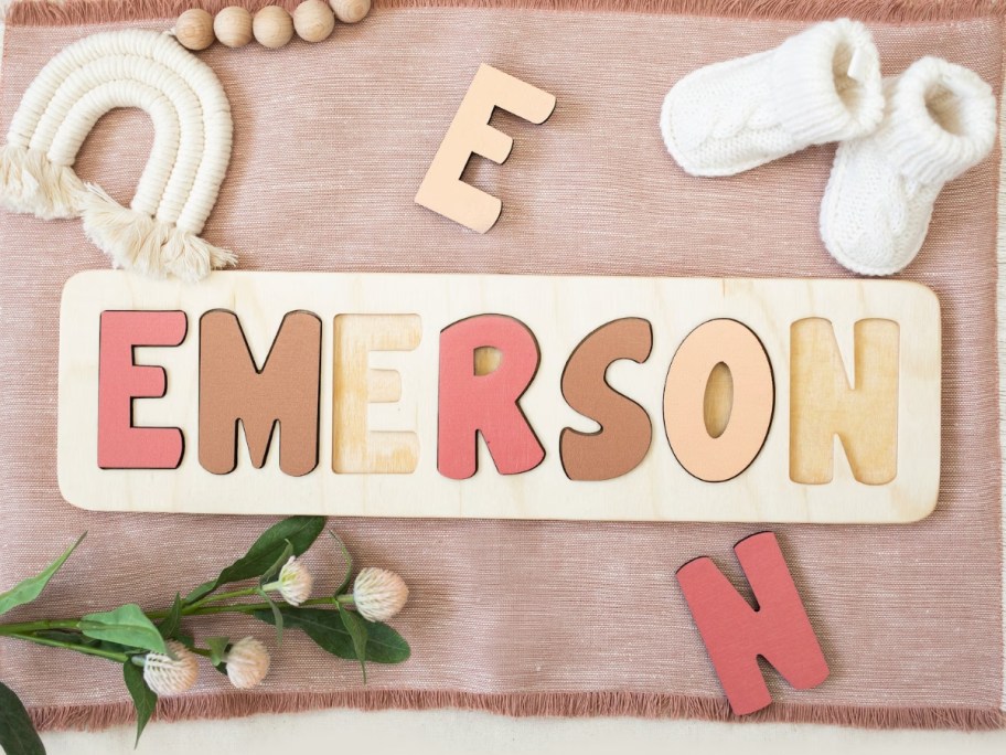 a kids wooden puzzle with her name Emerson