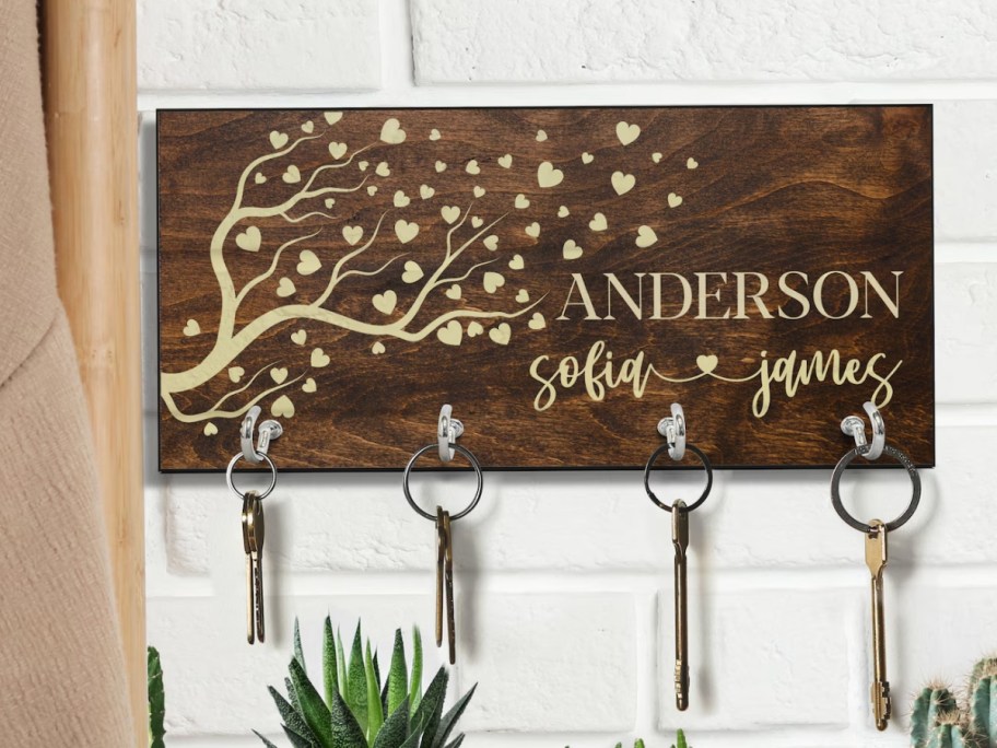 a wooden key holder with custom engraved image and names