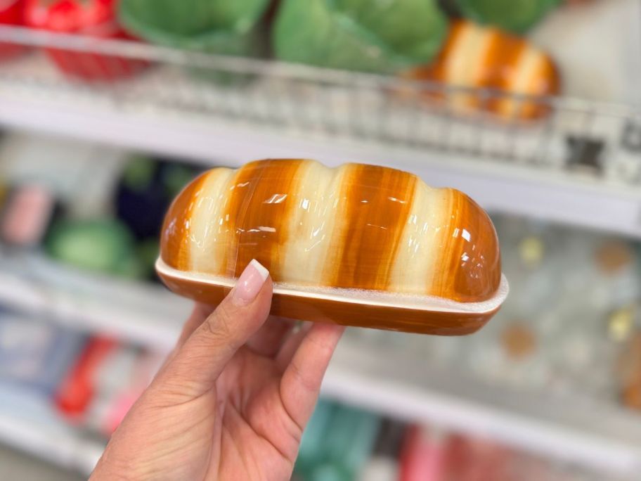 A person holding ceramic Baguette Butter Dish 