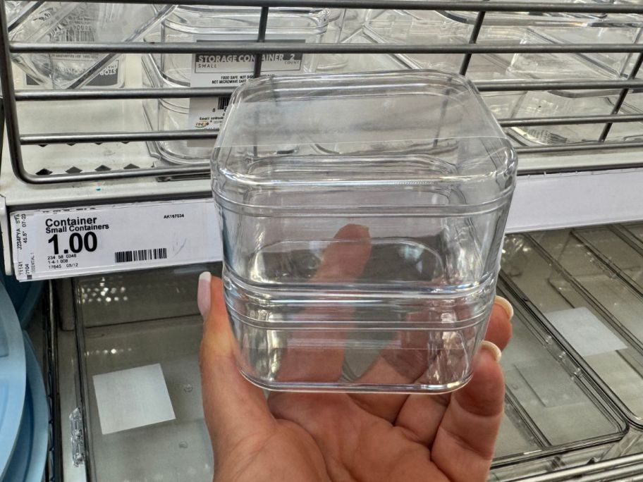 A person holding plastic bins 