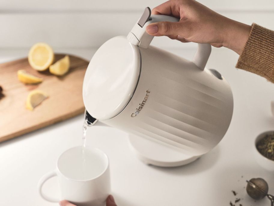 Hand pouring a Cuisinart Soho Collection Electric Kettle