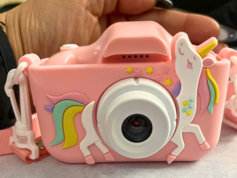 a kids pink digital camera with a unicorn on it