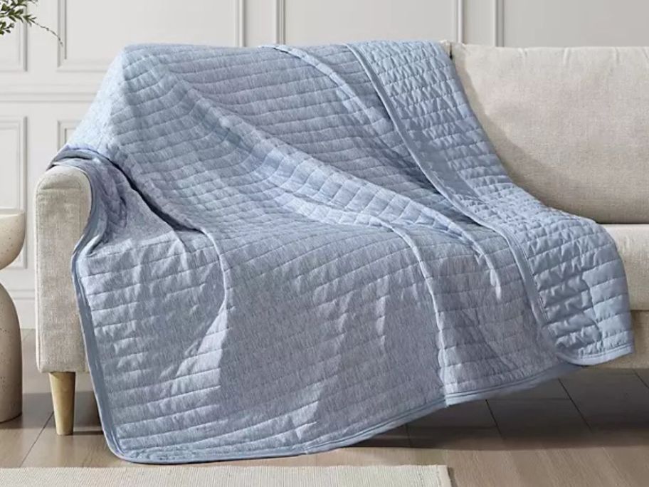 Blue Hudson & Main Cooling throw draped on a couch