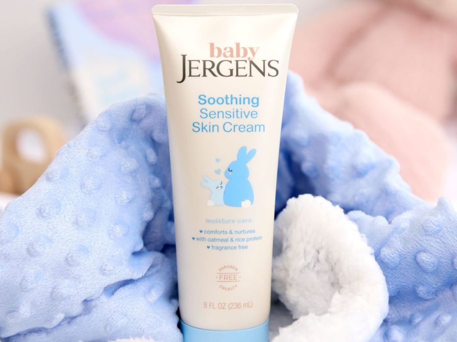 Jergen's Baby Sensitive Skin Cream next to a minky baby blanket