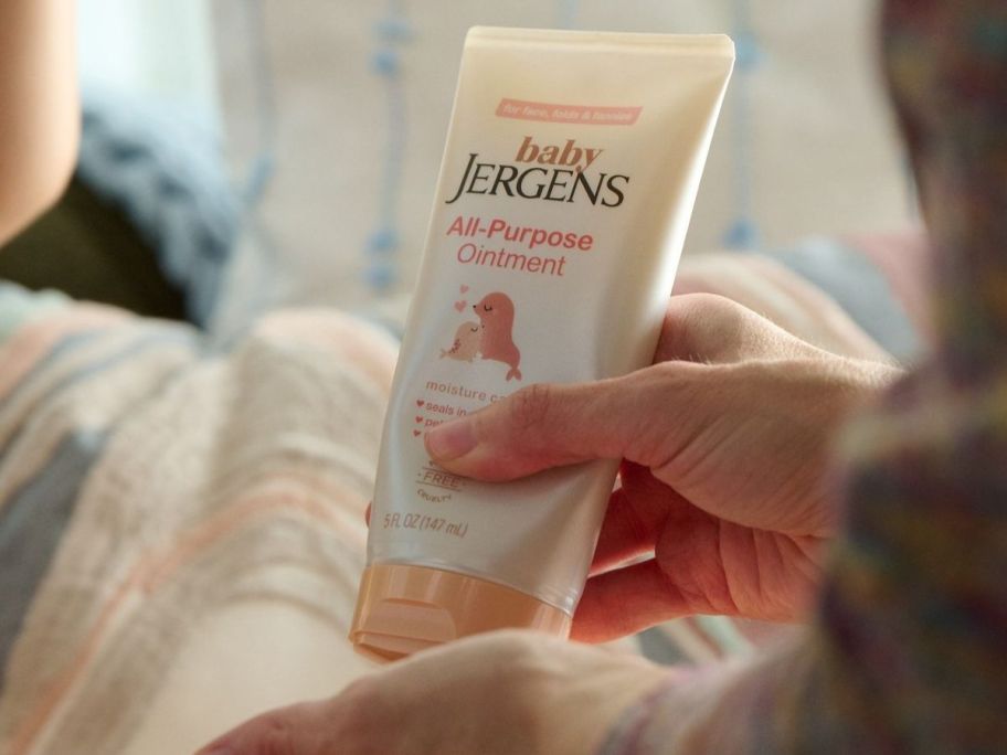 Hand squirting Jergen's Baby All Purpose ointment onto the other hand
