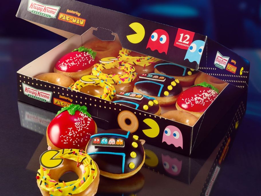 A dozen Krispy Kreme Specialty Doughnuts i a pac-man theme box with 3 doughnuts set in front of it