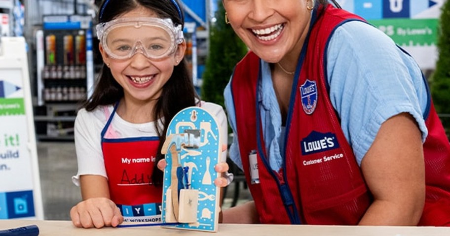 Lowe's Door Knocker Craft being held by a little girl with a woman