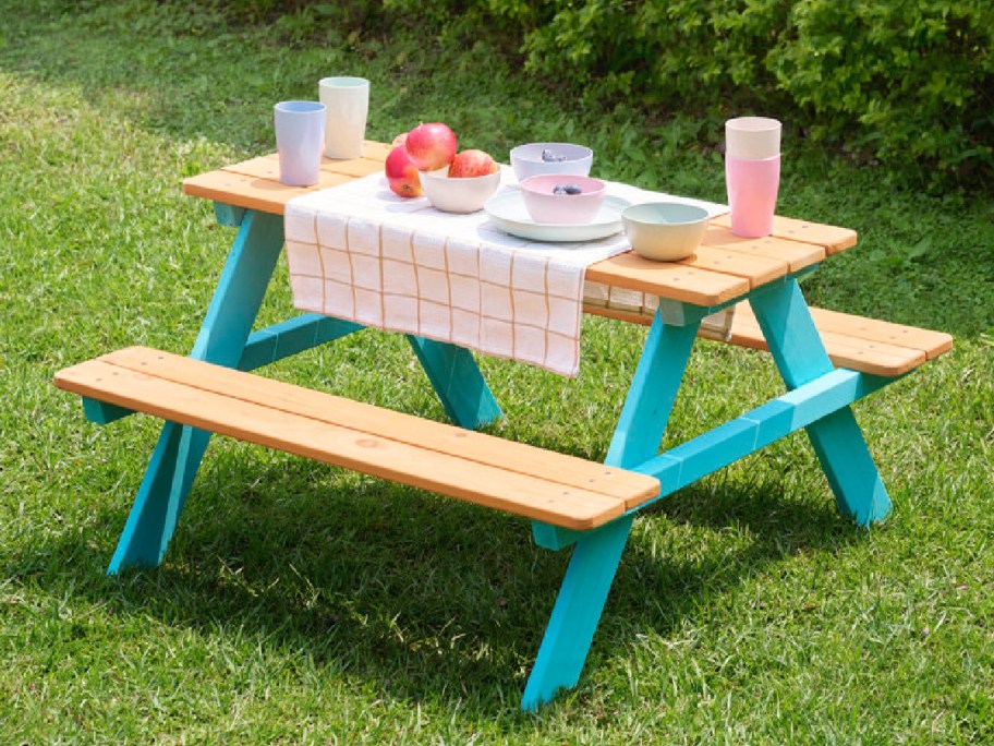 Kids picnic table with items displayed on it 
