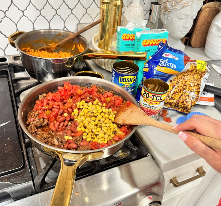 adding corn to taco mac and cheese with goodles