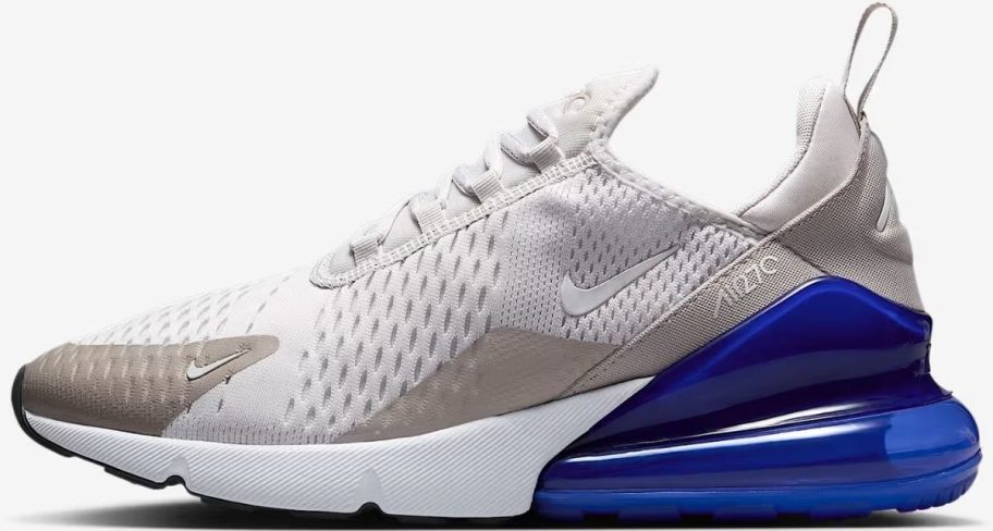 A white, beige and blue mens Nike running shoe