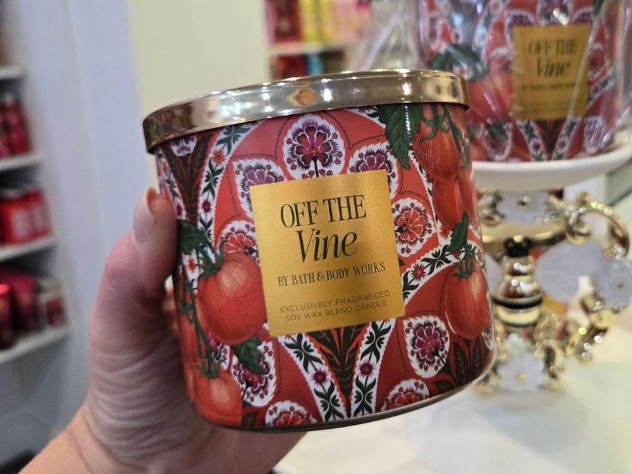 Bath & Body Works Off The Vine 3-Wick Candle in hand in store