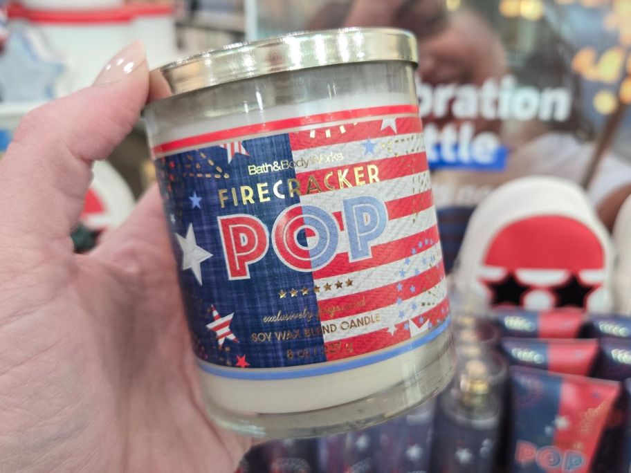 Bath & Body Works Firecracker Pop Single Wick Candle in hand in store