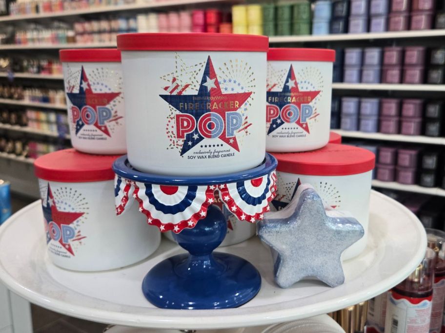 bath and body works firecracker pop candle, holder, and bath fizzy on display in store