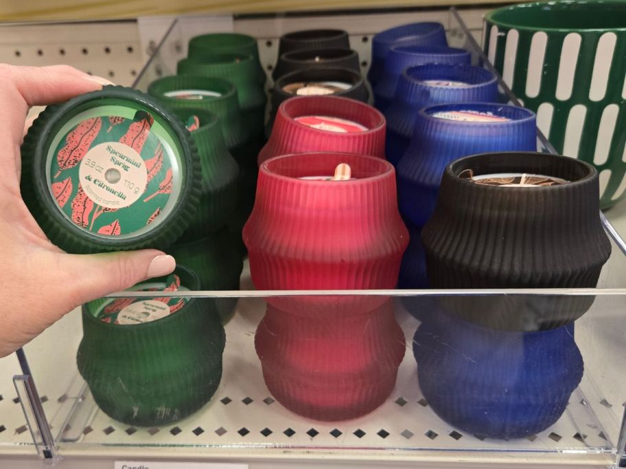 green, pink, and blue Citronella Candles on shelf in store