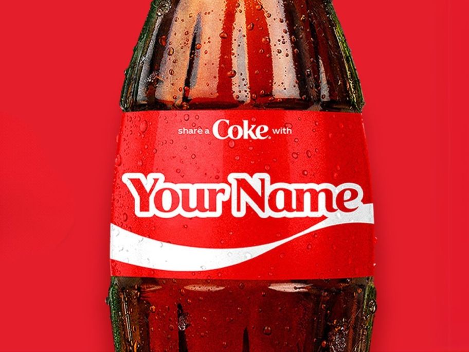 glass coke bottle with label personalized with "your name" against a red background