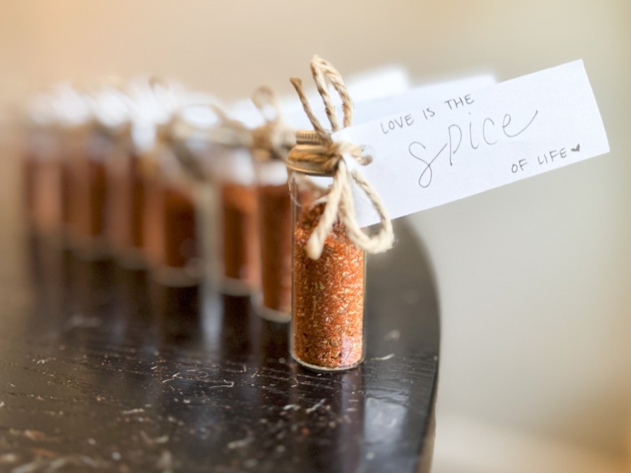 mini glass bottles with tag that says love is the spice of life