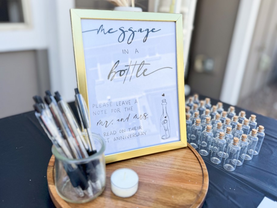 gold frame next to jar of pens 