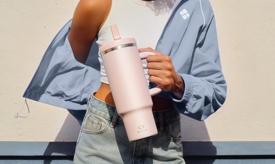 woman holding pink tumbler