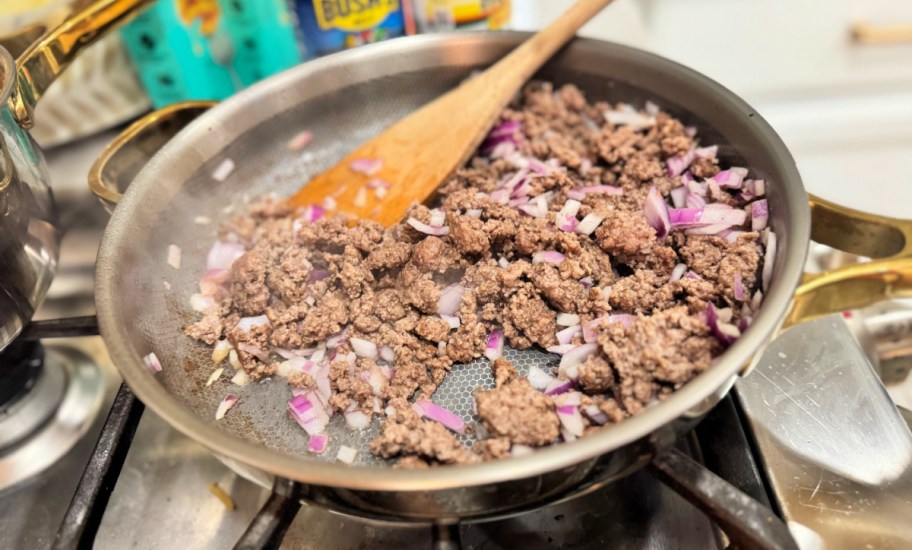 ground beef and onions cooking on a skillet 