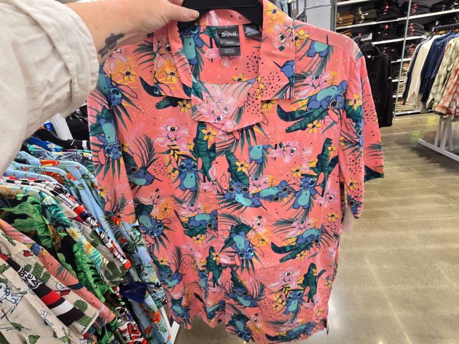 pink and blue Disney Stitch Men's Hawaiian Shirt in hand in store