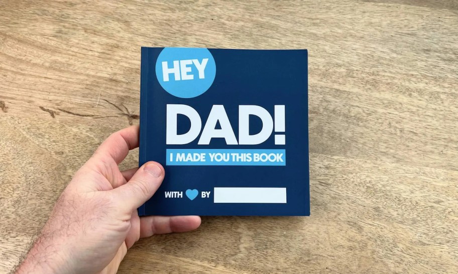 hand holding hey dad book 
