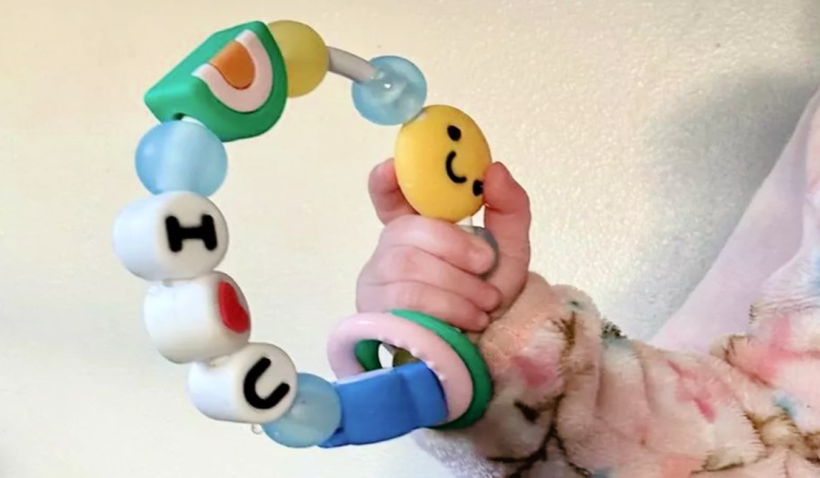 infantino teether in a baby's hand