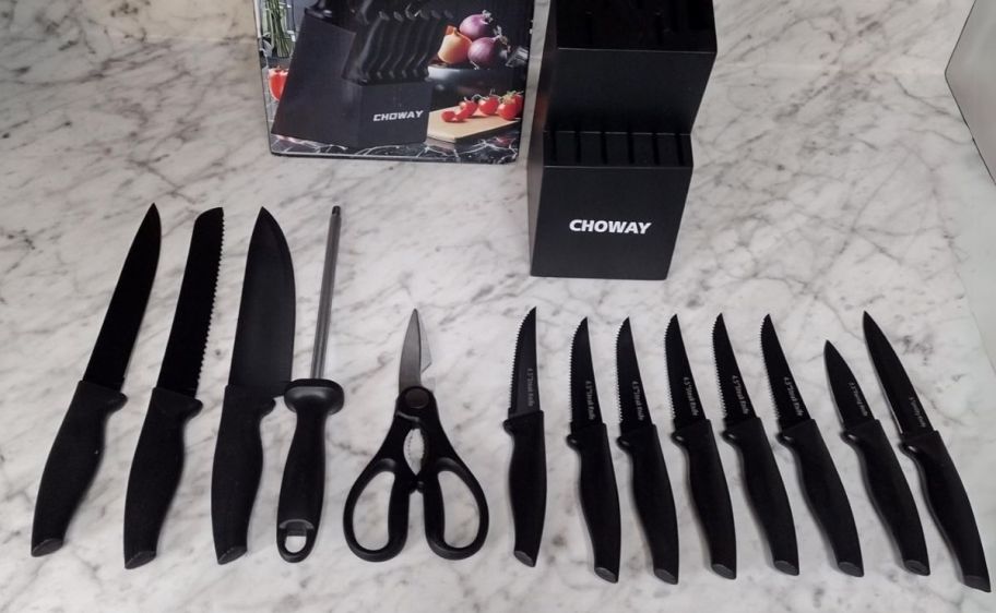 a 14 piece knife set shown with black knife block and packaging. displayed on a countertop