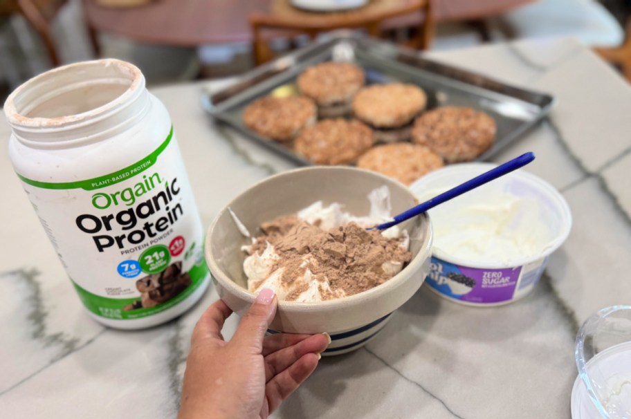 mixing orgain protein powder in a bowl with cool whip 