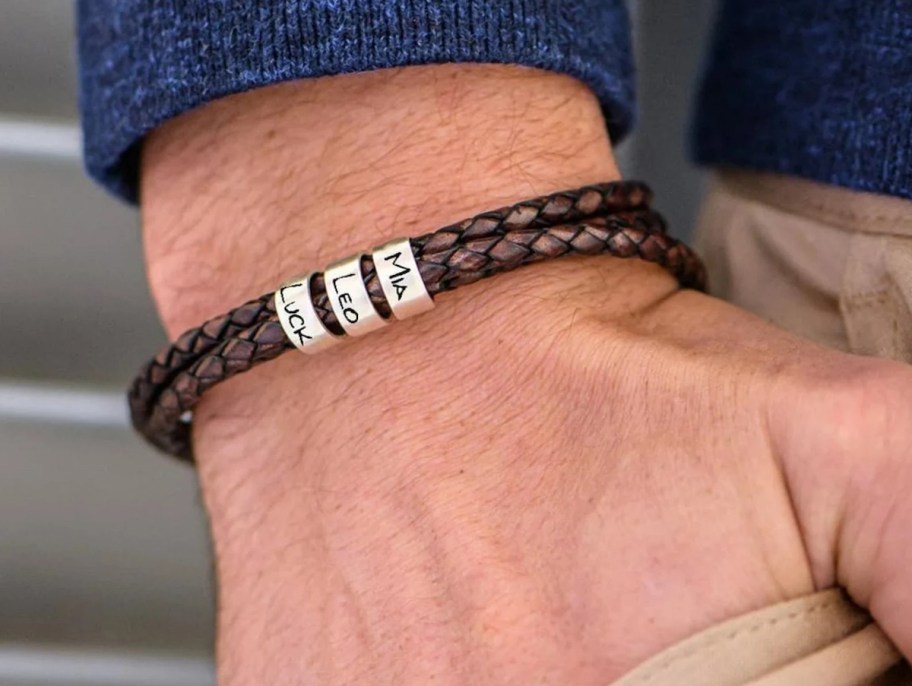 close up of leather braided bracelet with silver name beads